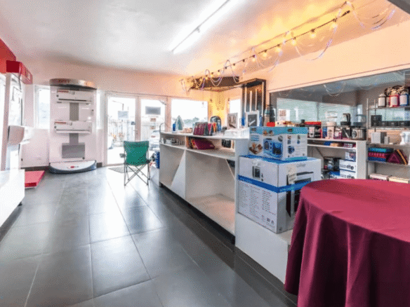 Showroom interior at the Commercial Office Space for Rent at Schotlandstraat 77-A Aruba featuring display shelving, counters, and open floor space.