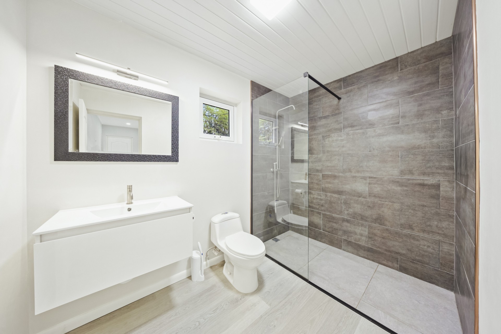 Modern bathroom with floating vanity and glass-enclosed walk-in shower at Pos Abao 10 F villa in Noord, Aruba.