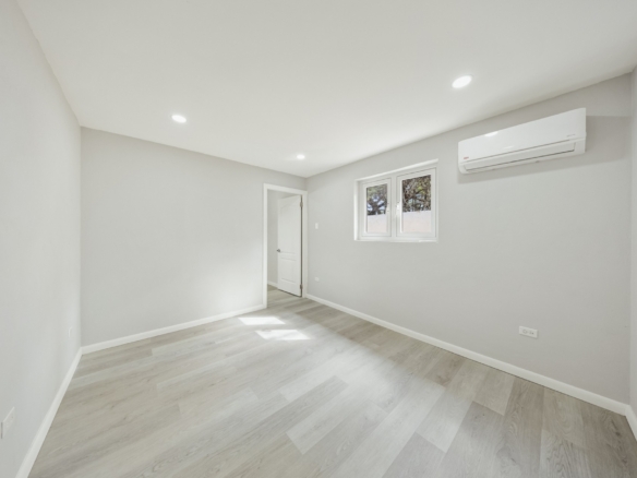 Bedroom with light flooring, natural light, and split air-conditioning unit at Pos Abao 10 F in Noord, Aruba.