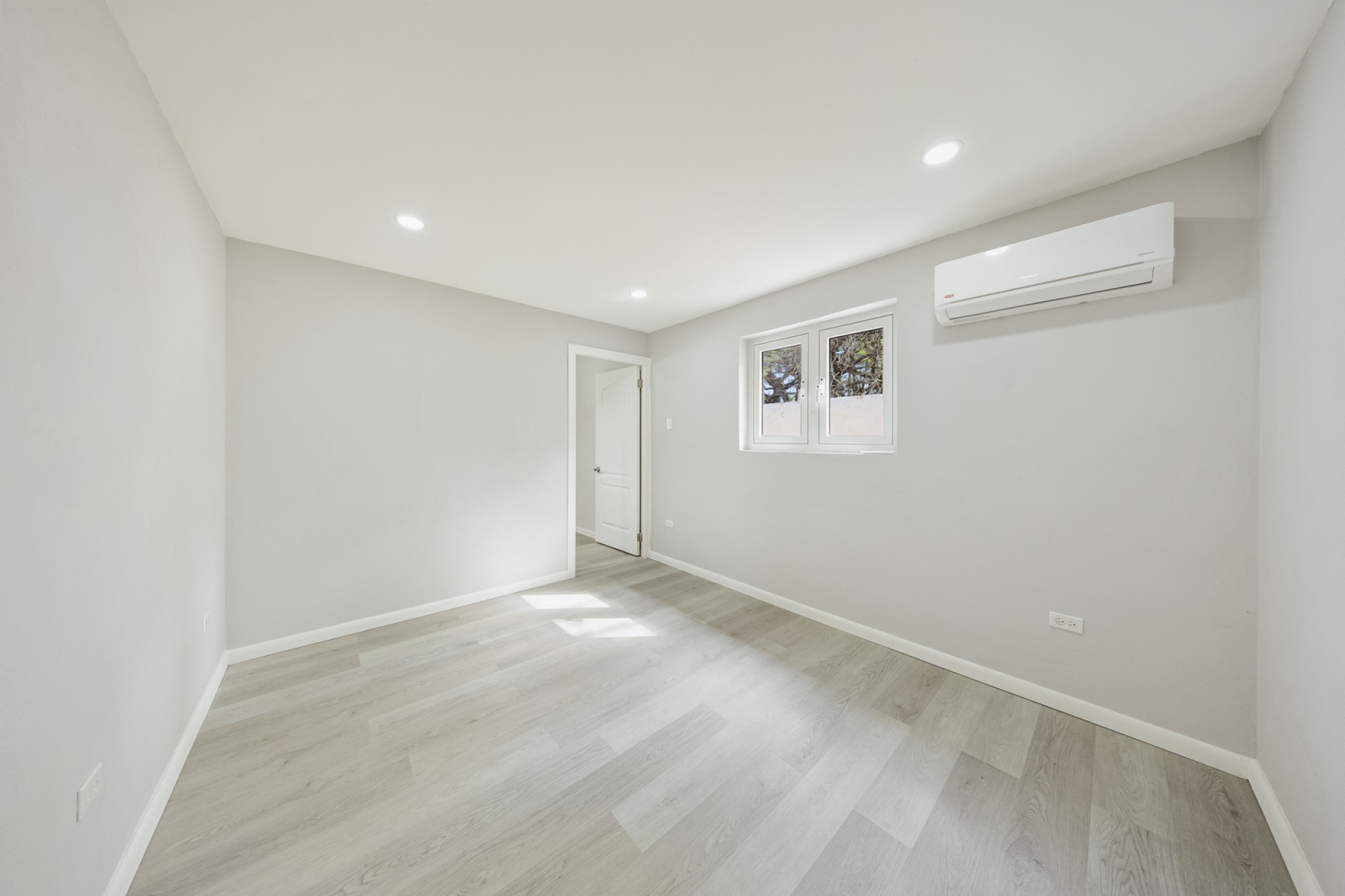Bedroom with light flooring, natural light, and split air-conditioning unit at Pos Abao 10 F in Noord, Aruba.