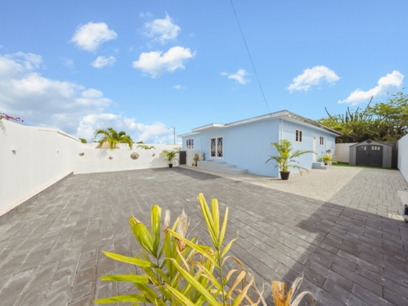 Swimming pool with views of the Pos Abao 10 F villa exterior and surrounding patio areas in Noord, Aruba.
