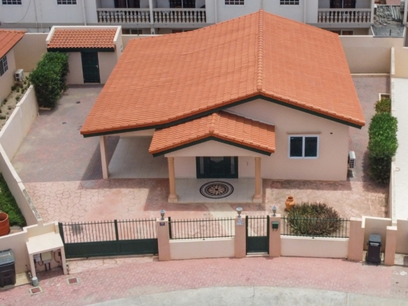 Aerial view of Tanki Leendert 123-B showing the home, driveway, covered parking, and enclosed yard.