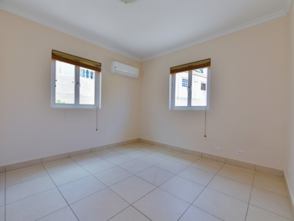 Bedroom with tiled flooring, air conditioning, and natural light in Tanki Leendert 123-B Aruba.