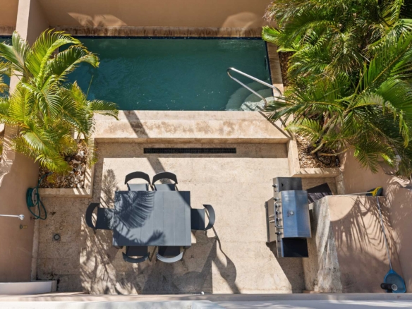 Private pool patio with outdoor dining and BBQ area at LeVent Townhouse 13, Eagle Beach Aruba