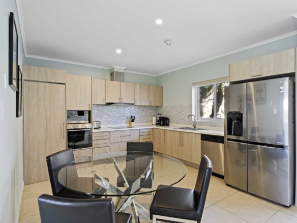 Fully equipped modern kitchen with dining area at LeVent Townhouse 13, Eagle Beach Aruba