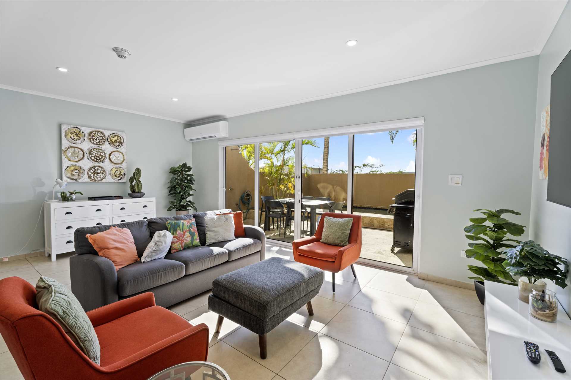 Living room opening onto the private patio at LeVent Townhouse 13, Eagle Beach Aruba