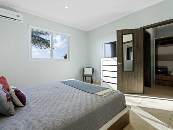Primary bedroom suite with closet and furnishings at LeVent Townhouse 13, Eagle Beach Aruba