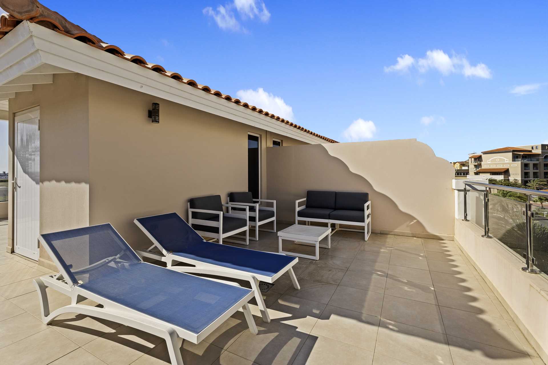 Private rooftop terrace with lounge seating at LeVent Townhouse 13, Eagle Beach Aruba