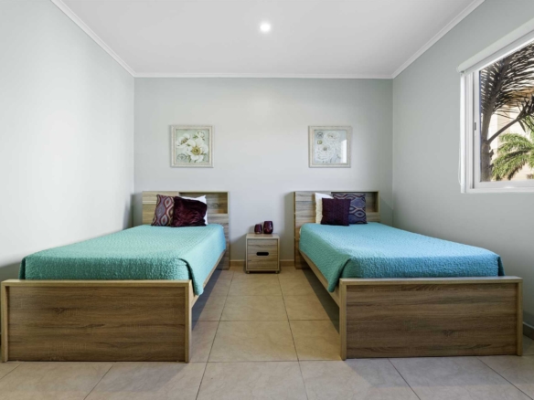 Second bedroom with two twin beds at LeVent Townhouse 13 in Eagle Beach, Aruba