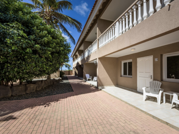 Exterior walkway and apartment building at Marquee Apartments in Noord, Aruba.