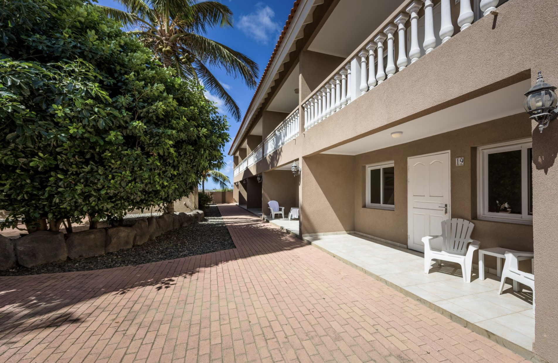 Exterior walkway and apartment building at Marquee Apartments in Noord, Aruba.