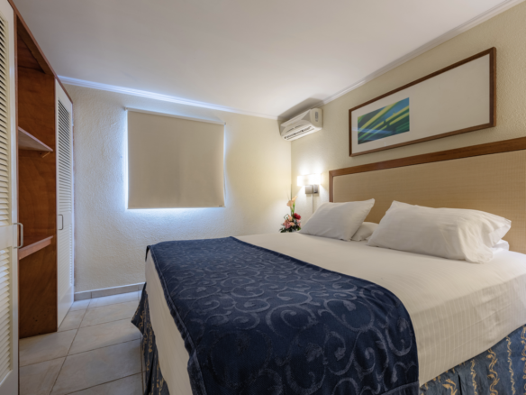 Furnished bedroom with air conditioning at Marquee Apartments in Noord, Aruba.