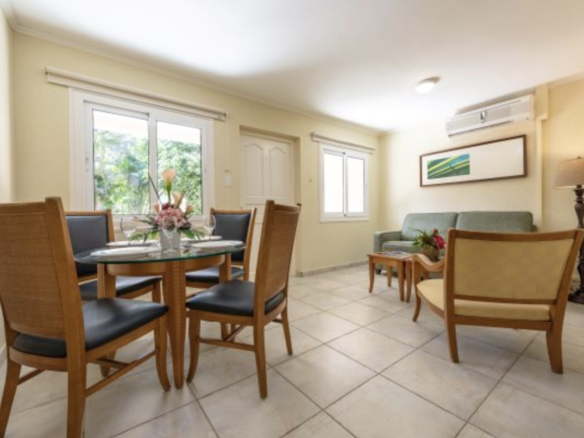 Furnished living and dining area inside an apartment at Marquee Apartments in Noord, Aruba.
