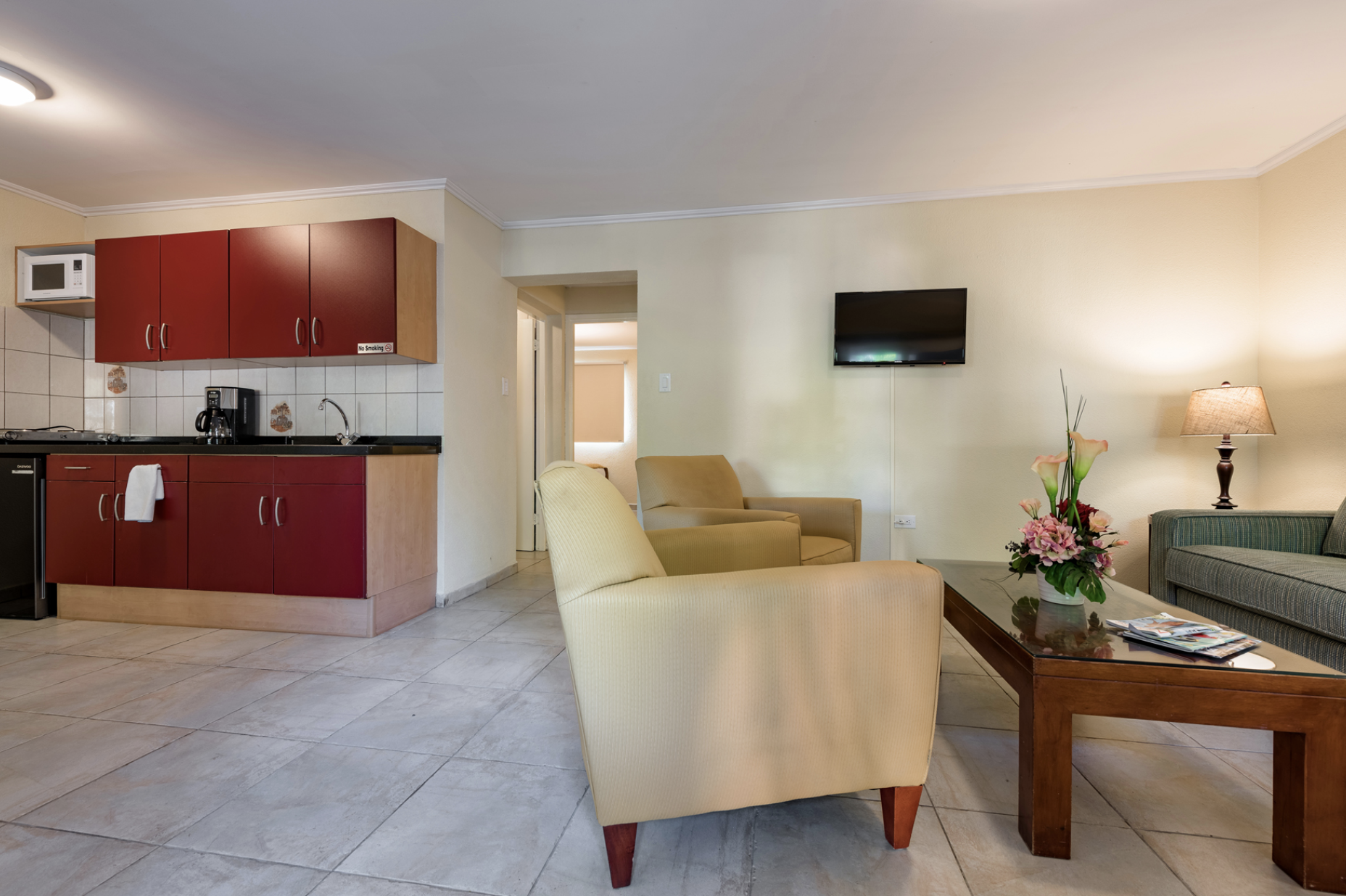 Furnished apartment living area with kitchen facilities at Marquee Apartments in Noord, Aruba.
